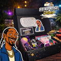 Surprise & Shine Lifestyle Box with Snoop Dogg graphic, containing rolling papers, cones, lighter, bath bomb, and stickers.